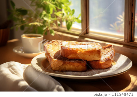 Traditional Spanish dessert Torrijas. Heap of a deep fried sweet bread on a plate in the sunlight 111548473