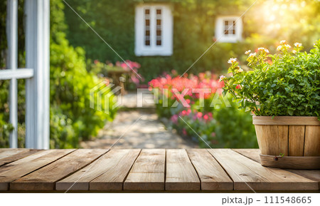 An empty wooden table in the foreground, with a blurred country house in the background against a verdant garden setting An empty wooden table in the foreground, with a blurred country house in the background against a verdant garden setting 111548665