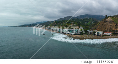 Malibu beach aerial view in California near Los Angeles, USA. Waves hitting the shore near expensive houses in Malibu. 111550281