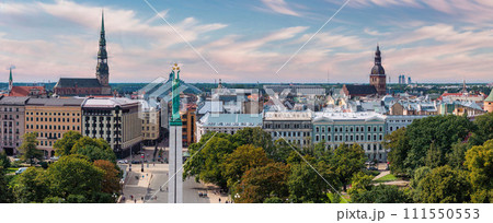 Beautiful sunrise view over Riga by the statue of liberty - Milda in Latvia. The monument of freedom. Beautiful sunrise view over Riga by the statue of liberty - Milda in Latvia. The monument of freedom. 111550553