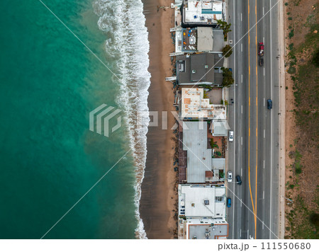 Malibu beach aerial view in California near Los Angeles, USA. Waves hitting the shore near expensive houses in Malibu. 111550680