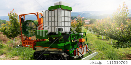 Autonomous robot sprayer works in a fruit garden. Smart farming concept Autonomous robot sprayer works in a fruit garden. Smart farming concept 111550706