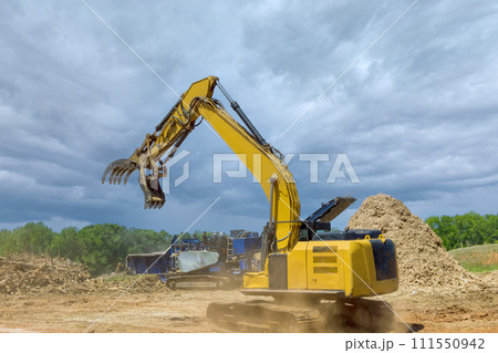 Forestry mulcher in loading roots trees to of industrial shredder machine chopped wooding Forestry mulcher in loading roots trees to of industrial shredder machine chopped wooding 111550942