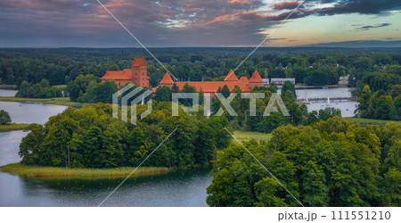 Aerial view of Trakai, over medieval gothic Island castle in Galve lake. Flat lay of the most beautiful Lithuanian landmark. Trakai Island Castle, most popular tourist destination in Lithuania Aerial view of Trakai, over medieval gothic Island castle in Galve lake. Flat lay of the most beautiful Lithuanian landmark. Trakai Island Castle, most popular tourist destination in Lithuania 111551210