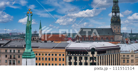 Beautiful sunrise view over Riga by the statue of liberty - Milda in Latvia. The monument of freedom. Beautiful sunrise view over Riga by the statue of liberty - Milda in Latvia. The monument of freedom. 111551514