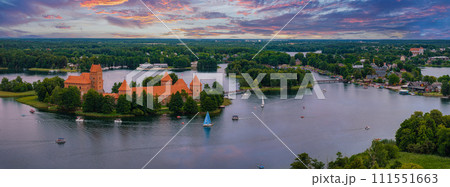 Aerial view of Trakai, over medieval gothic Island castle in Galve lake. Flat lay of the most beautiful Lithuanian landmark. Trakai Island Castle, most popular tourist destination in Lithuania Aerial view of Trakai, over medieval gothic Island castle in Galve lake. Flat lay of the most beautiful Lithuanian landmark. Trakai Island Castle, most popular tourist destination in Lithuania 111551663