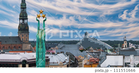 Beautiful sunrise view over Riga by the statue of liberty - Milda in Latvia. The monument of freedom. Beautiful sunrise view over Riga by the statue of liberty - Milda in Latvia. The monument of freedom. 111551666