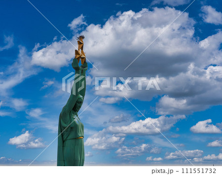 Beautiful sunrise view over Riga by the statue of liberty - Milda in Latvia. The monument of freedom. 111551732