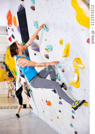 Woman exercising in climbing gym 111553212