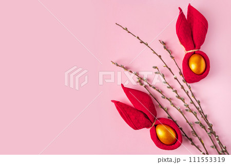 Easter bunny and golden shiny eggs on pink background. Easter bunny and golden shiny eggs on pink background. 111553319