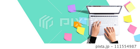 Laptop computer with many sticky notes 111554987