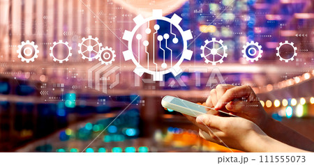 Automation concept with person using a smartphone in city at night Automation concept with person using a smartphone in city at night 111555073