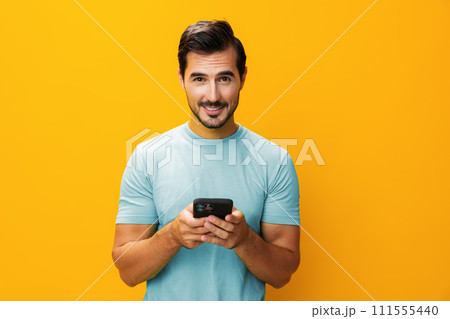 Man cyberspace smiling communication copy space yellow mobile phone happy smartphone portrait phone Man cyberspace smiling communication copy space yellow mobile phone happy smartphone portrait phone 111555440