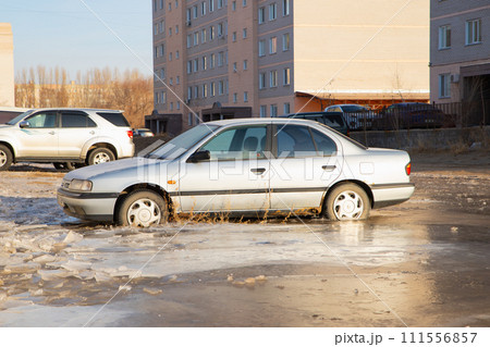 old Nissan Primera car in frozen water. winter accident. Pavlodar, Kazakhstan - 12.28.2022. 111556857