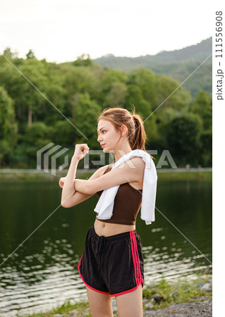 Happy slim woman wearing sportswear in the garden at sunrise. Young beautiful asian female in sports bra running outdoor. Workout exercise in the morning. Healthy and active lifestyle concept. 111556908