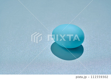 Blue Easter egg on a blue background. Blue Easter egg on a blue background. 111559302