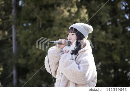 冬に路上ライブをする若い女性 冬に路上ライブをする若い女性 111559848