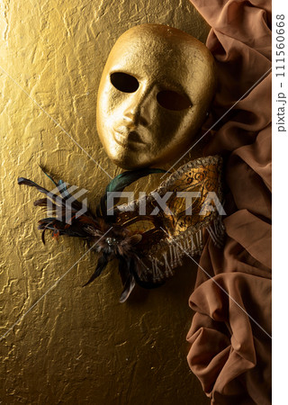 Vintage Venetian carnival masks masks on a golden background. Vintage Venetian carnival masks masks on a golden background. 111560668