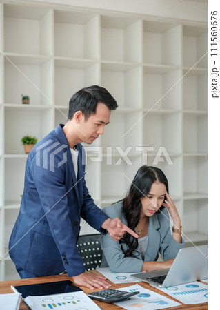 Two business workers smiling happy working sitting on desk at the office. Two business workers smiling happy working sitting on desk at the office. 111560676