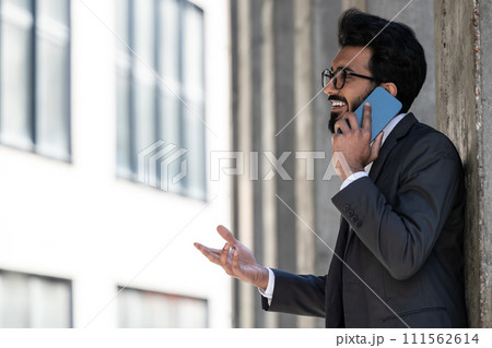 Stylish young businessman in office area with a phone in hands 111562614