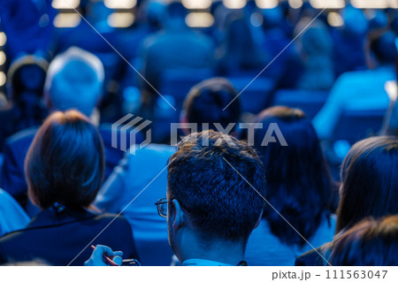 Audience listening attentively at a professional business conference Audience listening attentively at a professional business conference 111563047