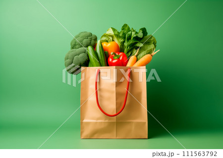Craft brown shopping paper bag and grocery on blue background. Delivery concept 111563792
