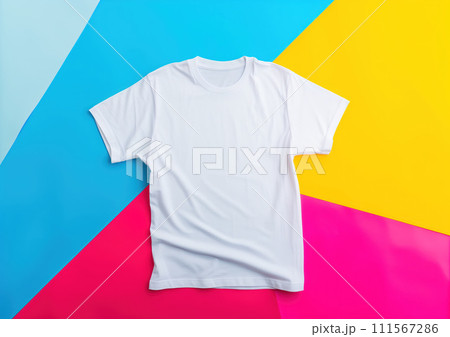 Top view, advertising shot from above of white clean t-shirt on blue yellow pink background 111567286