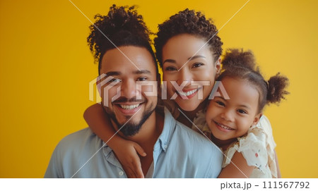 Joyful Afro American family with child on yellow background. 111567792