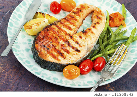 Plate of grilled salmon steak. 111568542