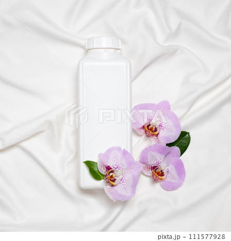Natural fabric softener on satin fabric with orchid flowers 111577928