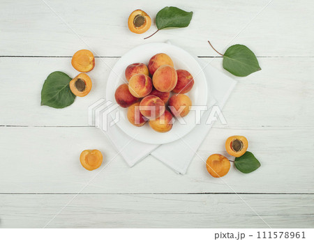 Ripe apricots on the table.  apricots and green leaves. Flat lay. Top view. Copyspace. 111578961