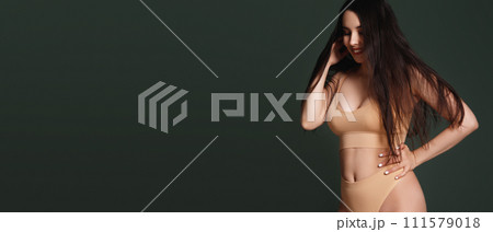 Fitness woman on green background. Beautiful 111579018