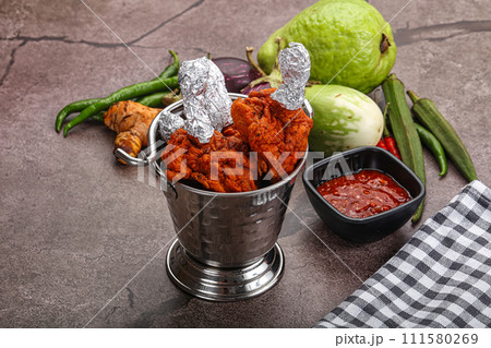Indian cuisine glazed chicken lollipop 111580269