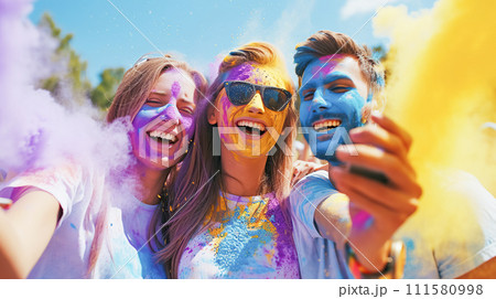 AI-generated content. A group of happy joyful modern young girls and boys look take a selfie, among clouds of blue and yellow Holi powder 111580998