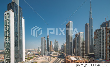 Aerial sunrise view of Dubai Downtown skyline with many towers night to day timelapse. Aerial sunrise view of Dubai Downtown skyline with many towers night to day timelapse. 111581367
