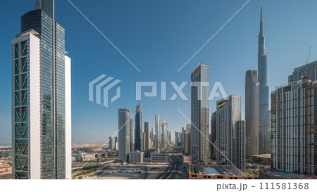 Aerial sunrise view of Dubai Downtown skyline with many towers night to day timelapse. 111581368