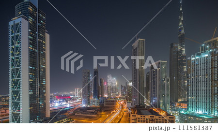 Aerial view of Dubai Downtown skyline with many towers day to night timelapse. Aerial view of Dubai Downtown skyline with many towers day to night timelapse. 111581387