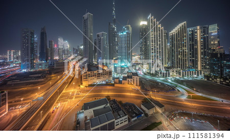 Aerial view of Dubai Downtown skyline with many towers day to night timelapse. Aerial view of Dubai Downtown skyline with many towers day to night timelapse. 111581394