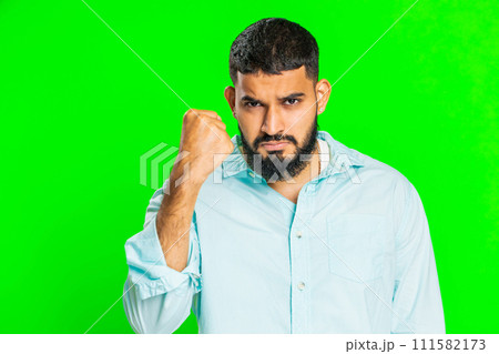 Aggressive angry Indian man trying to fight at camera, shaking fist, boxing, punishment, threaten 111582173