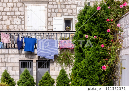 Rope with clean clothes outdoors in rural Europe 111582371