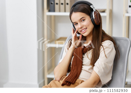 teenage girl music lifestyle phone meditation smile happy chair earphones 111582930