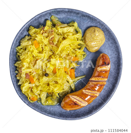 Braised cabbage with wiener and mustard on plate above, isolated 111584044