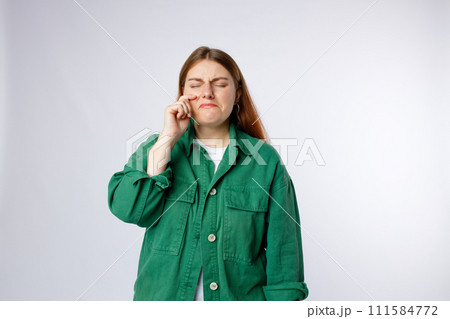 Sad crying disappointed funny woman isolated on background, Emotional, young face. Human emotions, facial expression concept. 111584772