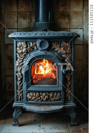 cast-iron stove in a rustic house with a fire lit inside to heat the house 111585118