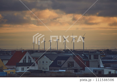 Wind energy next to village in denmark 111586506