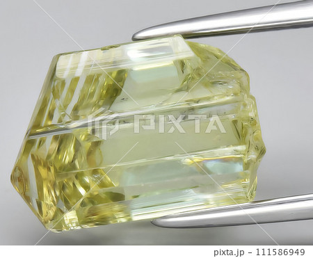 natural yellow tanzanite rough gem on the background natural yellow tanzanite rough gem on the background 111586949