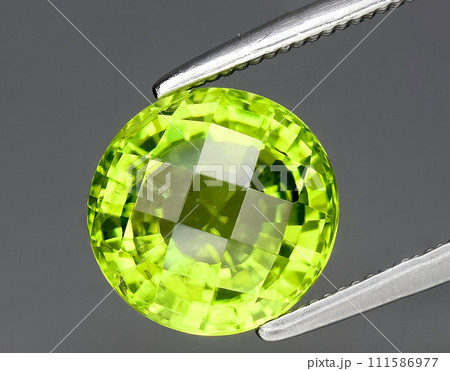 natural green peridot olivine gem on the background 111586977