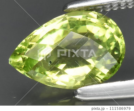 natural green peridot olivine gem on the background natural green peridot olivine gem on the background 111586979