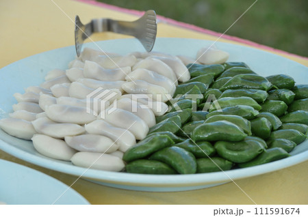 songpyeon, half-moon-shaped rice cake on buffet food songpyeon, half-moon-shaped rice cake on buffet food 111591674