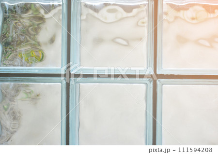 close up glass block wall with golden natural light background, interior design 111594208